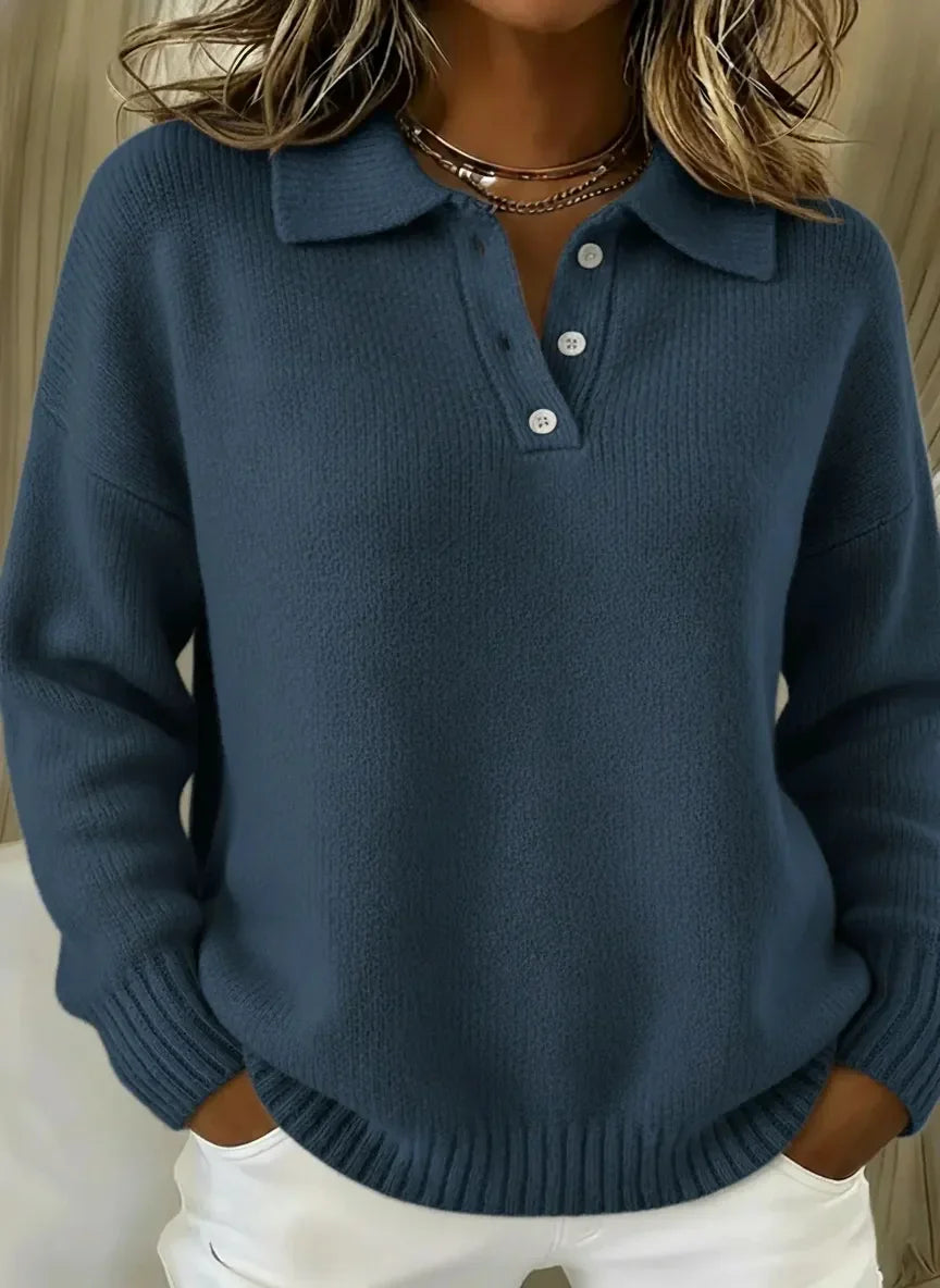 Blue knit polo sweater with relaxed fit, white buttons, and ribbed cuffs for women's stylish casual wear