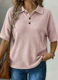 Pink waffle knit polo shirt for women, relaxed fit, breathable fabric, paired with jeans and brown bag