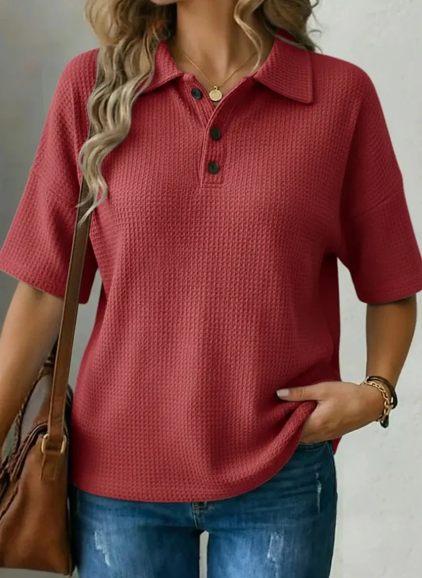 Red textured polo shirt for women, relaxed fit, paired with jeans and a brown bag