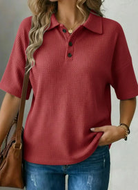 Red textured polo shirt for women, relaxed fit, paired with jeans and a brown bag