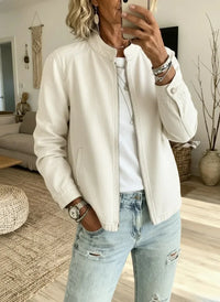Cream zip-up jacket with relaxed fit, styled with distressed jeans for mature women's casual wear