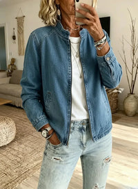 Mature woman in stylish denim jacket and ripped jeans, relaxed fit for sophisticated everyday wear