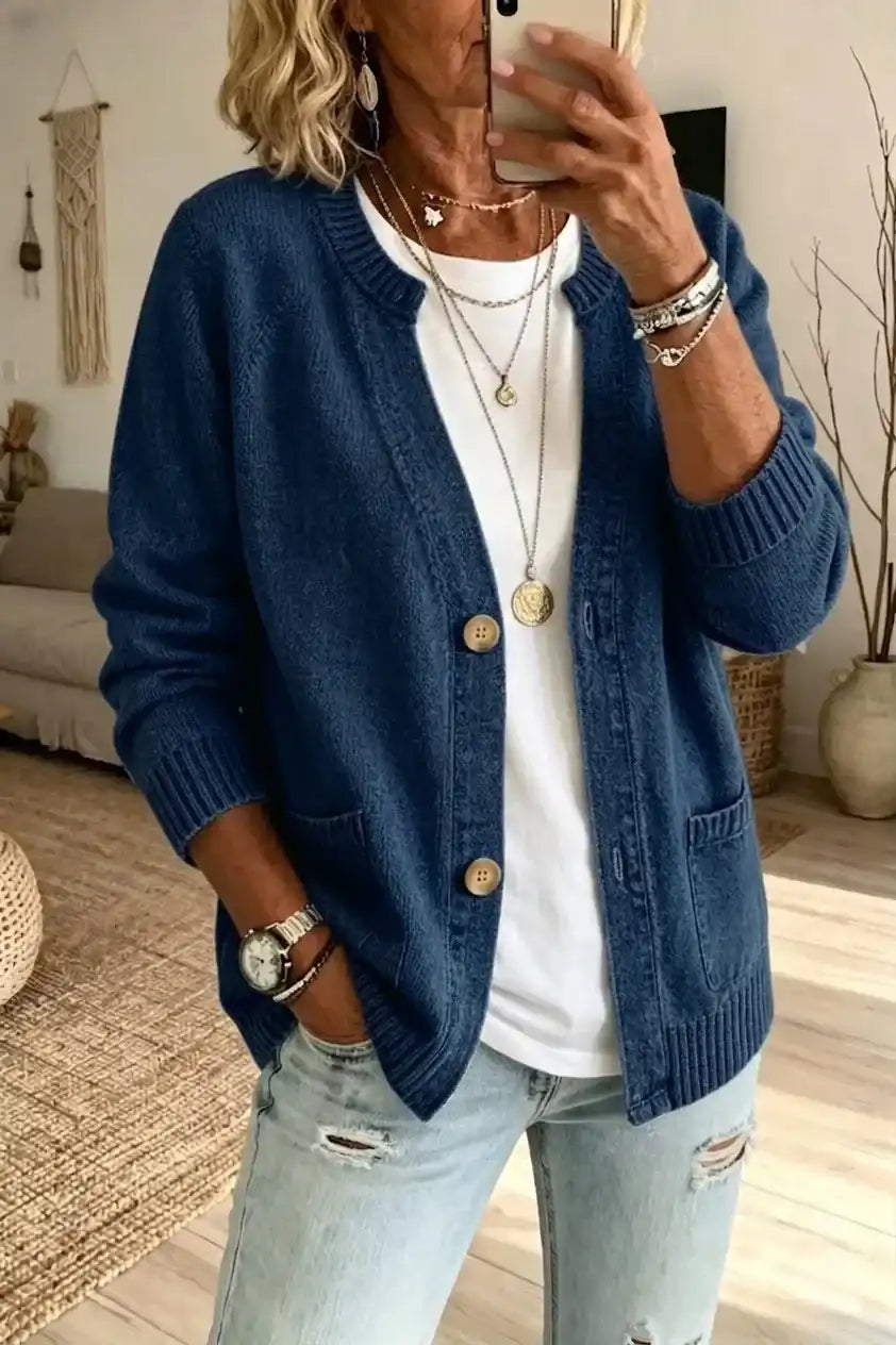 Blue knit cardigan with pockets, worn over white tee and ripped jeans, styled for mature women