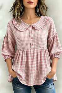 Pink gingham blouse with ruffled collar and puff sleeves for women, paired with jeans